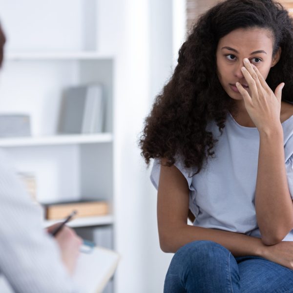 Beautiful african american girl during meeting with professional counselor